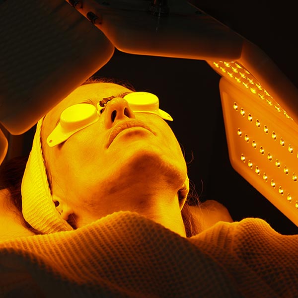 LED phototherapy / light therapy using yellow light on a woman's face