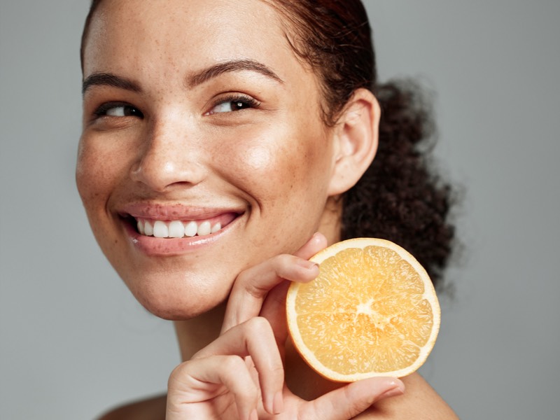 Woman holding fruit rich in vitamin C