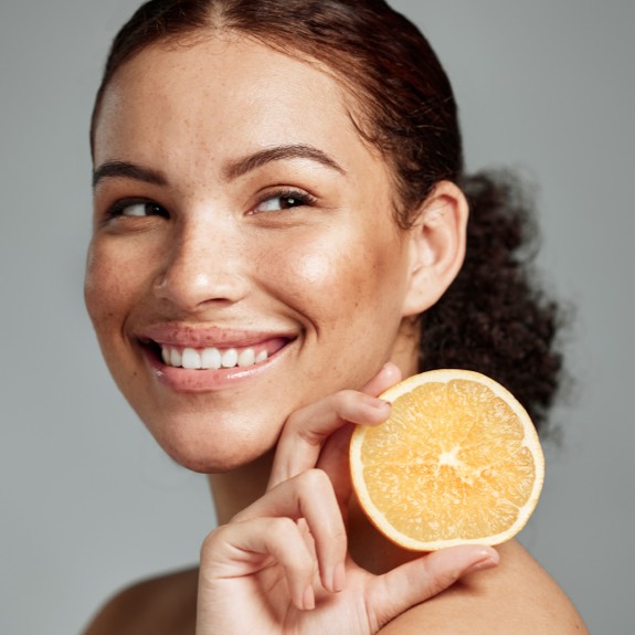 Woman holding fruit rich in vitamin C