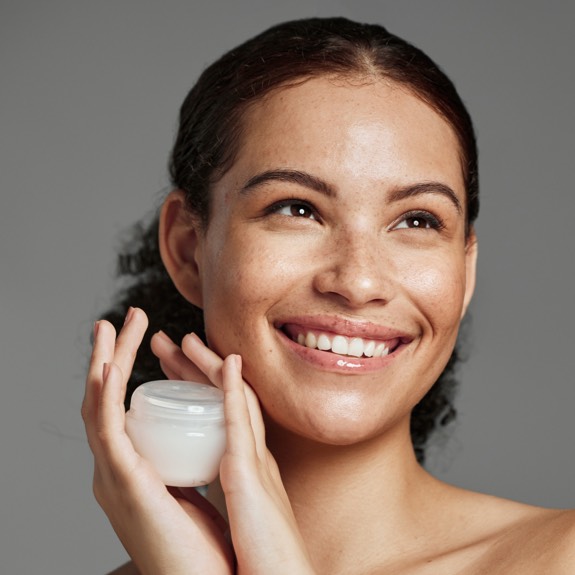 Woman using Topical vitamin B3 (niacinamide)